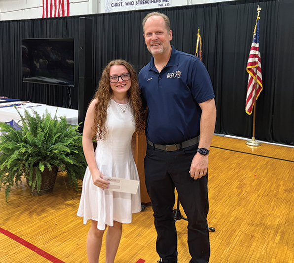Mary Alexis Price of Bessemer Academy is presented the Maxine Sykes Vocational Education Scholarship by Jason Jewell recently.