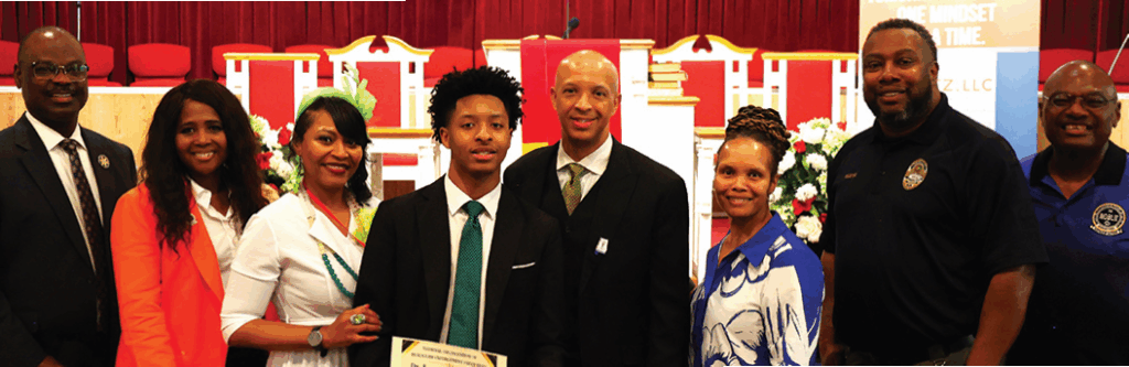 NOBLE's Alabama Chapter members and President Michael Williams present scholarship to Camden Washington with family