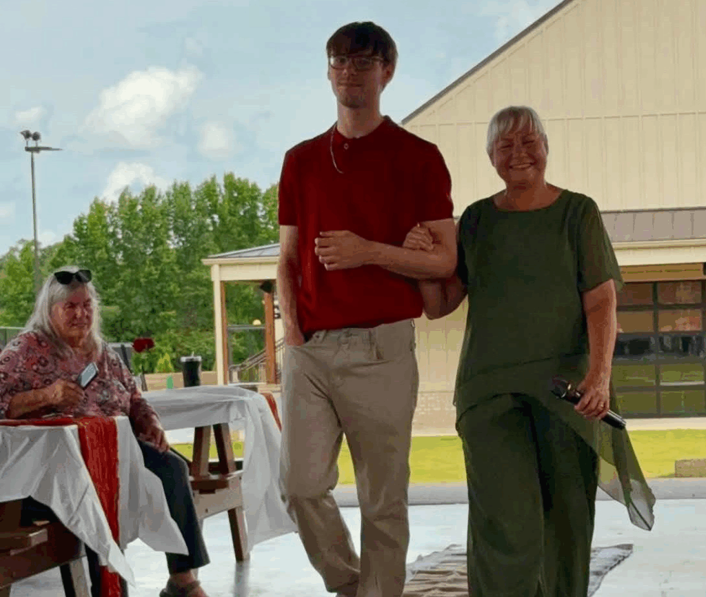 Cole Adams walks his grandmother, Dr. Wanda Manning, down the aisle.