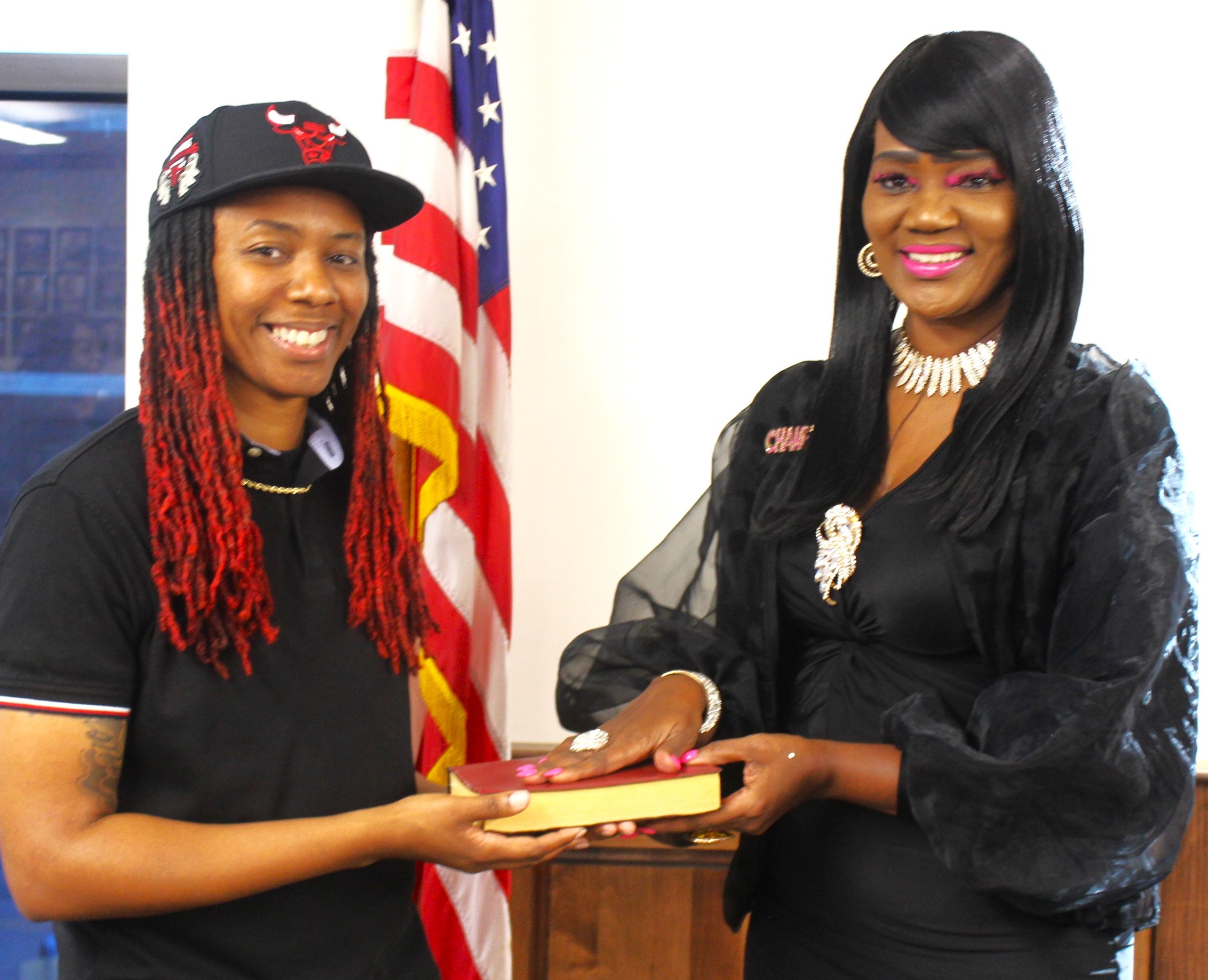 Elaine Holifield, newly elected to the Bessemer Board of Education, and her daughter Bianca share a light moment at the swearing-in.