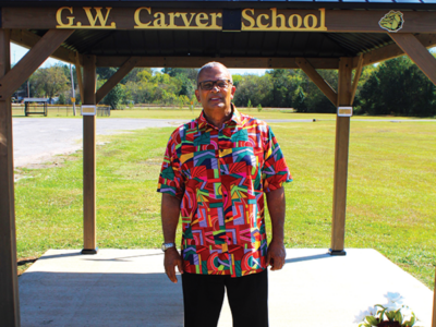 Dr. Fears poses before Carver School