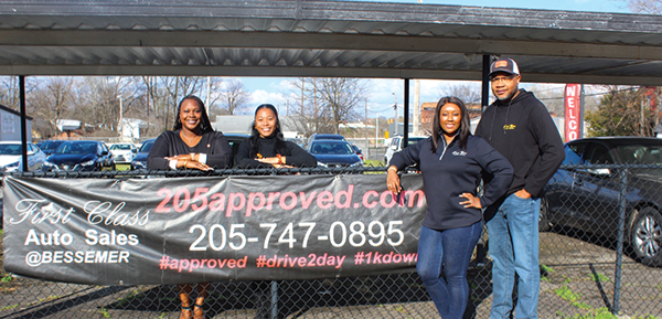 Mr. Erek Yarbrough, Mrs. Yarbrough and staff smile for the camera.