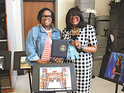 Rep. Sewell poses with Mrs. Kaysha Moore Davis, art teacher at Paul W. Bryant High School in Tuscaloosa, alongside the winning submission