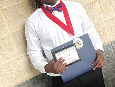 Aaden Hawkins pictured with awards during school awards day (above)