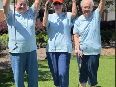 Golfers celebrating a successful putt
