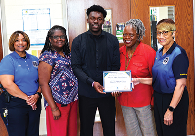 NOBLE members pose with student JaKyrie M. Chaney (above)