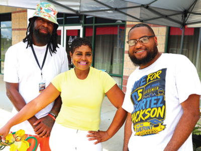 Jay Johnson, MeMe Jackson and Bessemer School Board candidate Geortez Jackson share smiles(above)