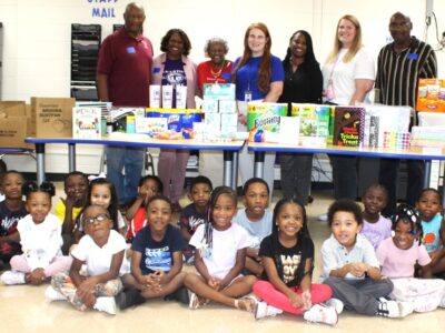 Pastor Scott, Principal Buckelew, Macedonia Baptist Church members and Abrams Elementary staff with kindergarten students.