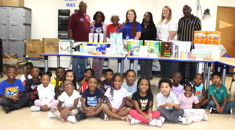 Pastor Scott, Principal Buckelew, Macedonia Baptist Church members and Abrams Elementary staff with kindergarten students.