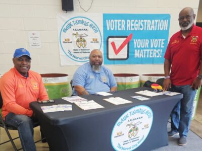 Members of Malik Temple #270 with voter registration forms at the temple's registration table