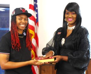Elaine Holifield, newly elected to the Bessemer Board of Education, and her daughter Bianca share a light moment at the swearing-in.
